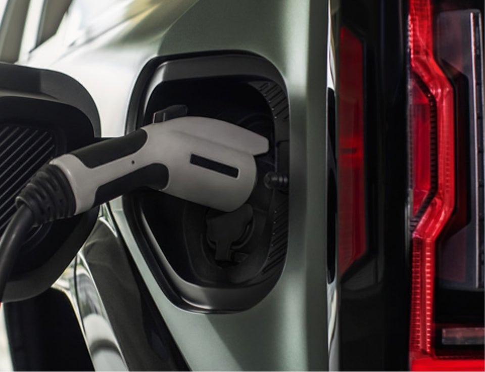 Close up of charging port with charger plugged in on a GMC Hummer EV SUV - Casa Buick GMC in EL PASO TX
