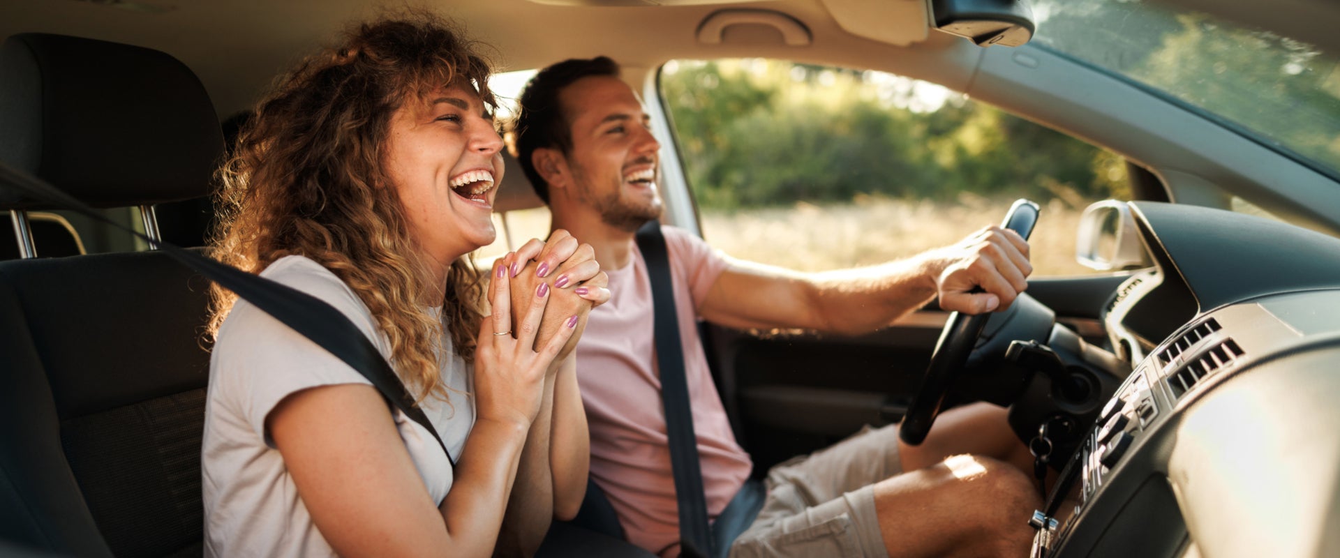 Couple driving off in their new car